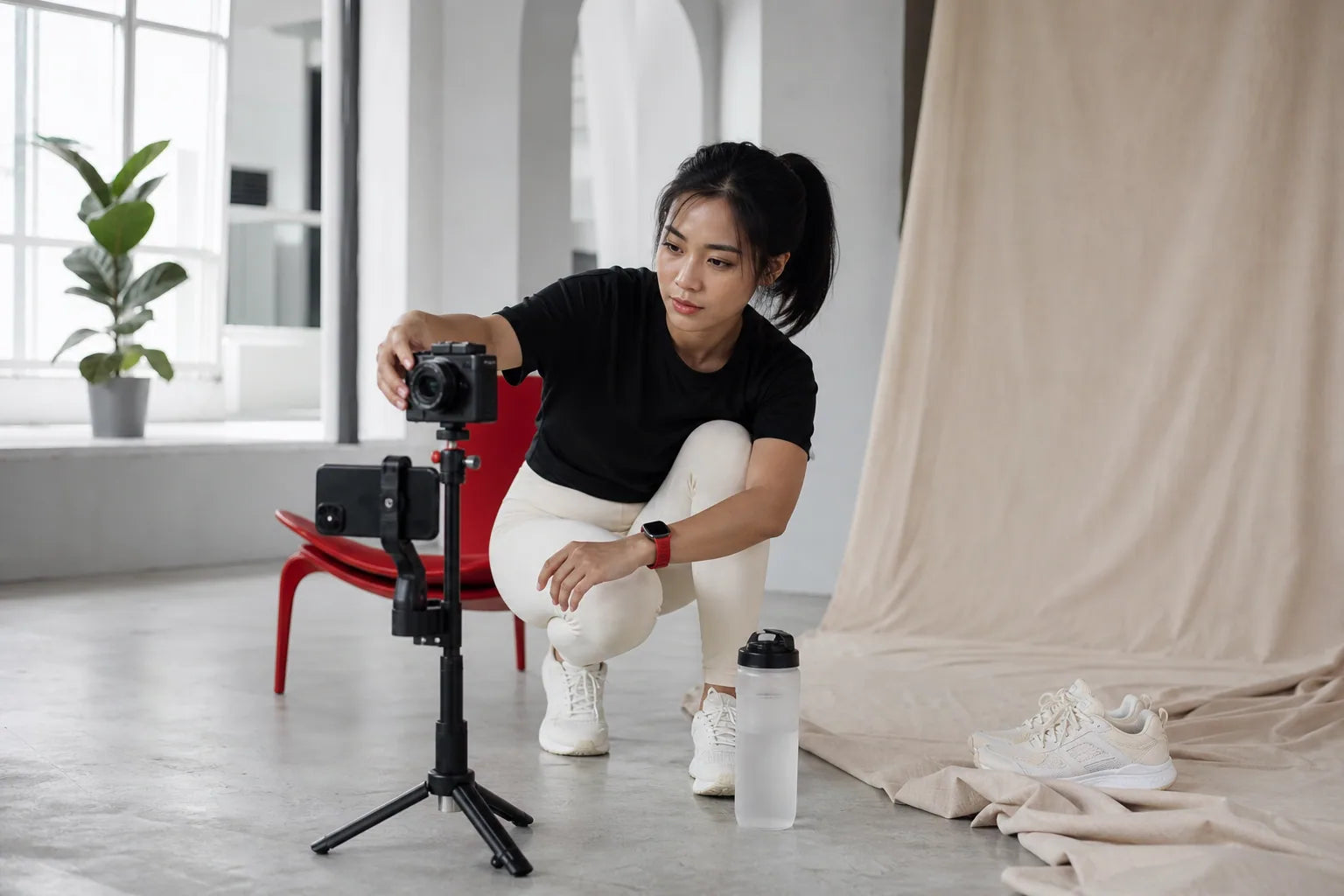 Creator filming XALT content in a warm white and red studio