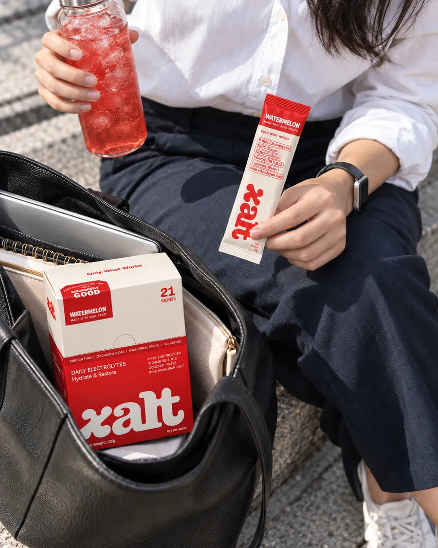 A drink, a Watermelon sachet and a box of XALT in a work bag