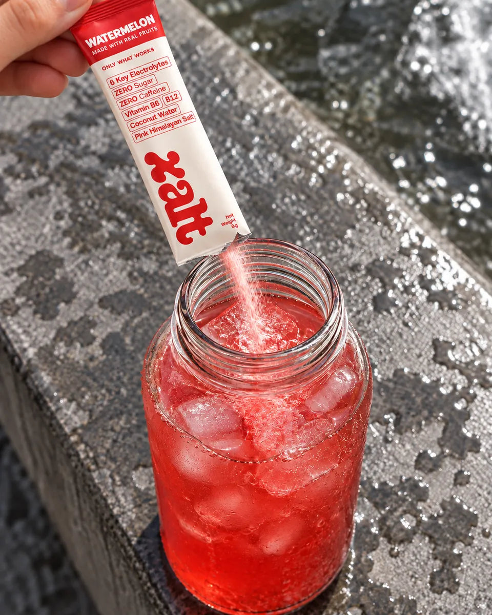 Cold XALT electrolyte drink pouring into a glass