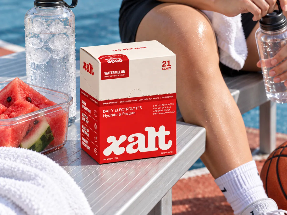 A box of XALT Watermelon on a courtside bench