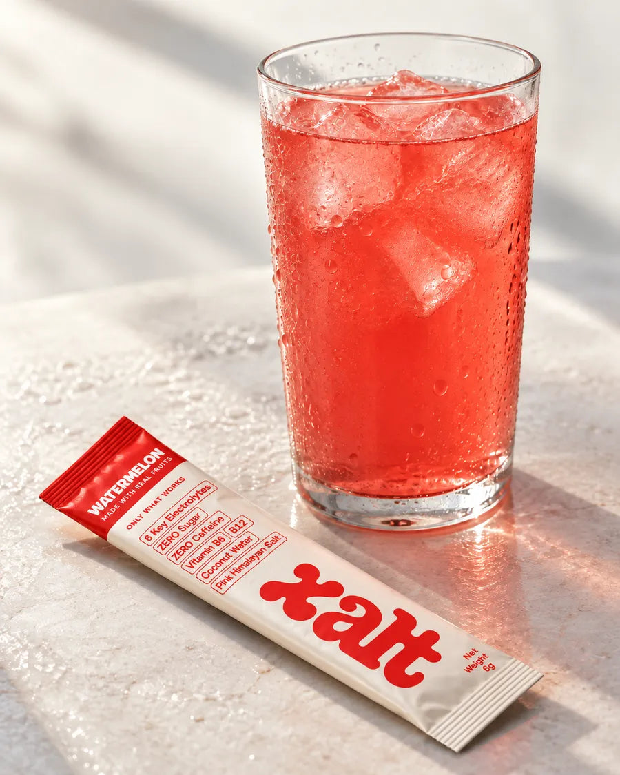 An iced glass of Watermelon XALT with a sachet beside it
